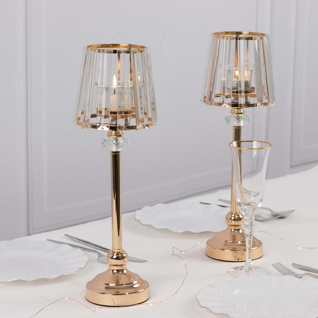 Elegant gold table lamps with crystal accents on a dining table setting.