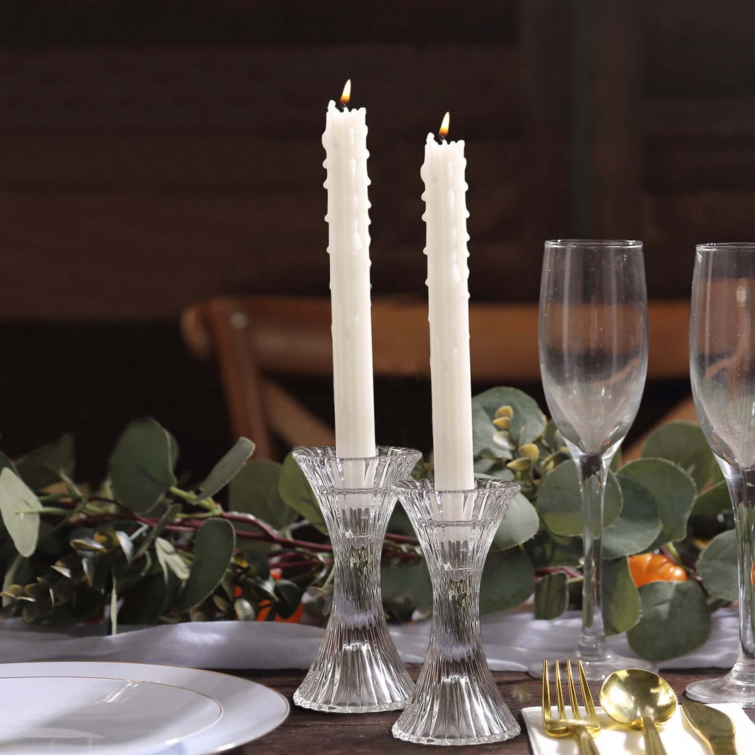 Elegant crystal candle holders with white candles, perfect for dining decor.