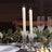 Elegant crystal candle holders with white candles, perfect for dining decor.