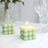 Green bubble candle in a stylish setting with elegant glassware.