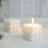 White bubble candle glowing softly on a light surface.
