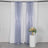 Lavender sequin curtains draped in a studio setting with a floral arrangement.