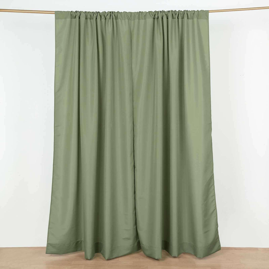 Olive green curtain panels hanging on a rod
