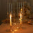 Elegant candle holders with lit candles and decorative lights.