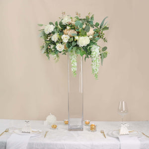 Elegant floral arrangement in a tall vase for table decoration.
