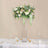 Elegant floral arrangement in a tall vase for table decoration.
