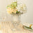 Elegant floral arrangement in a crystal vase on a linen tablecloth.
