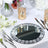 Elegant round mirror charger plate with crystal accents on a festive table setting.