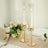 Elegant candle holders with candles and floral centerpiece on a table setting.