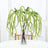 Artificial green hanging plant in a clear vase.