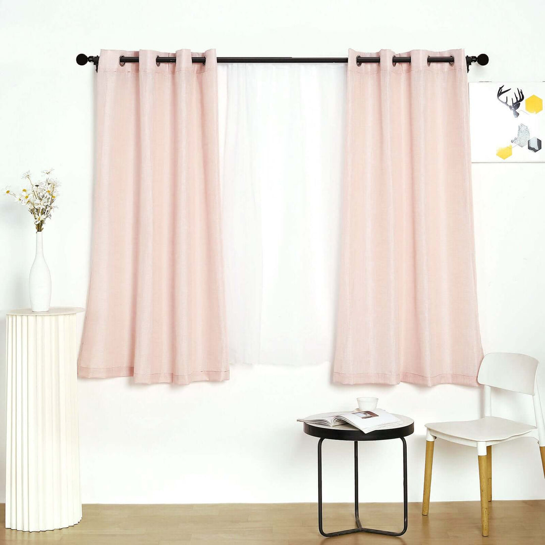 Soft pink curtains draping over a sheer panel in a modern living space.