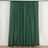 Green curtain panel with a pleated design on a white backdrop