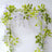 Artificial wisteria garland with green leaves on a white backdrop