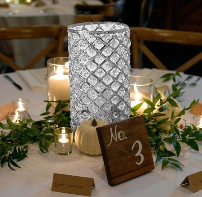 Elegant crystal candle holder on a decorated table setting with candles.