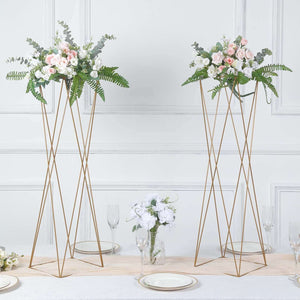 Floral arrangements on gold stands for elegant table decor