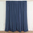 Navy blue curtain panels hung on a rod in a studio setting