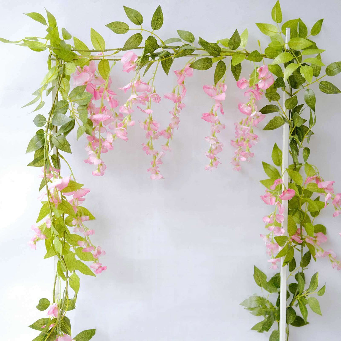 Pink flower garland with green leaves, perfect for decoration