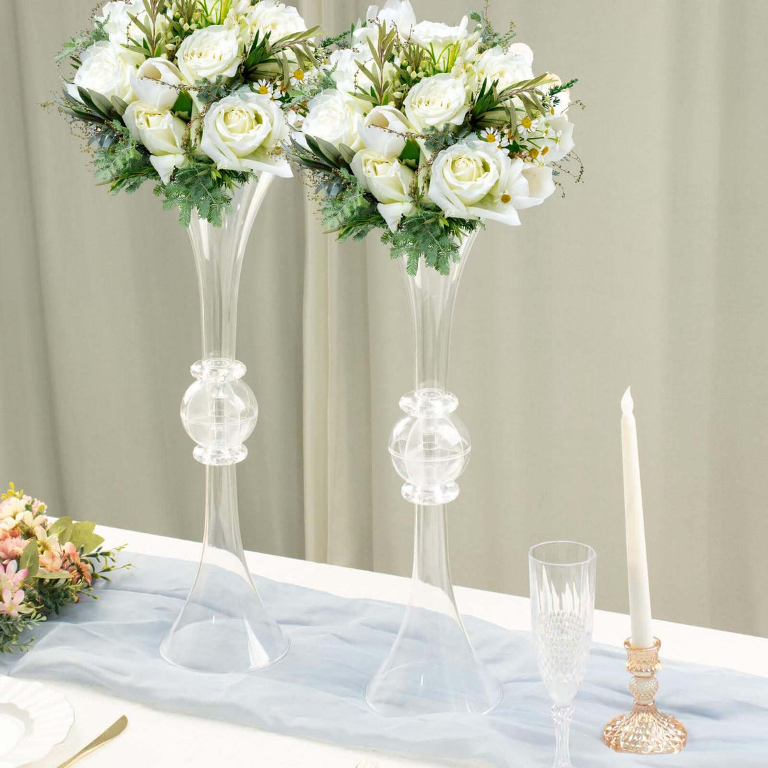 Elegant floral arrangements in crystal vases for table decor.