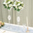 Elegant floral arrangements in crystal vases for table decor.
