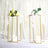 Elegant floral centerpieces in gold candle holders on a table.
