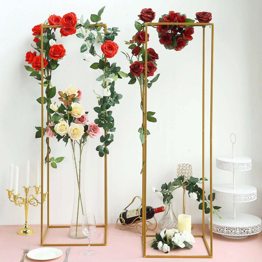Elegant gold floral arch with roses and greenery for event decor.