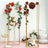 Elegant gold floral arch with roses and greenery for event decor.