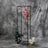 Decorative floral display with candles in a modern black frame.