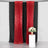 Red sequin backdrop curtains with black drapes and a white pedestal table.