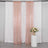 Rose gold sequin curtains draped with a floral arrangement on a pedestal.