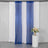 Blue sequin curtain drapes on a white backdrop with a floral arrangement.