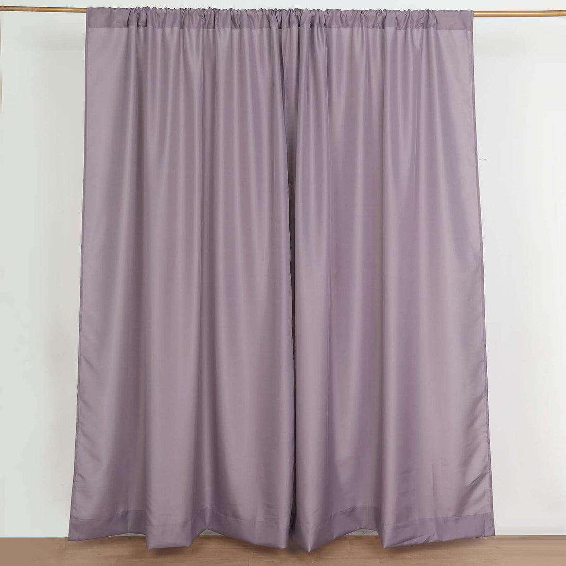 Purple curtain panels on a plain background for elegant window decor.