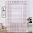 Sheer striped pink and white curtains hanging in a stylish living room setting.