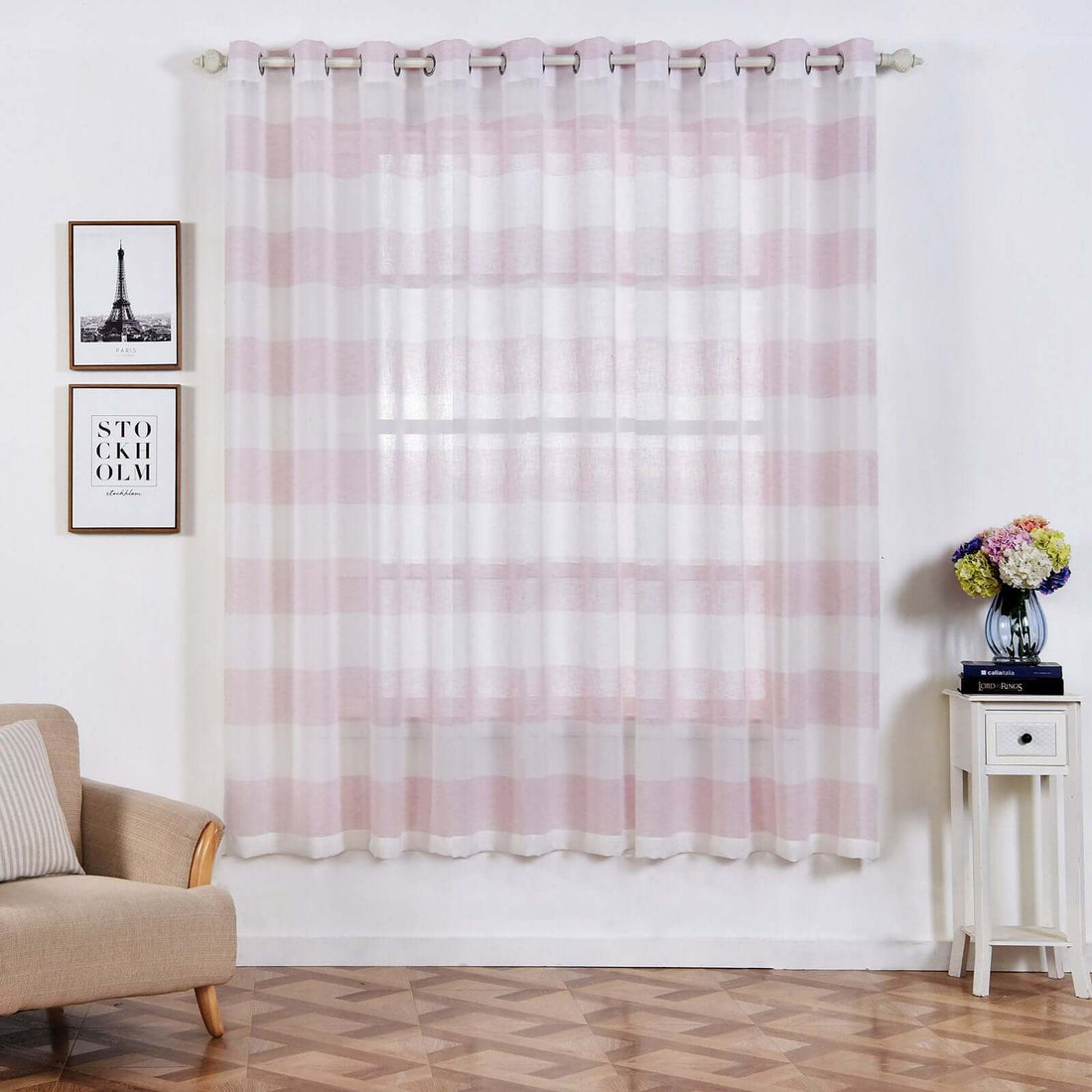 Sheer pink and white striped curtain hanging in a stylish living room.