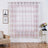 Sheer pink and white striped curtain hanging in a stylish living room.