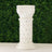 White decorative column with diamond embellishments on a green background.