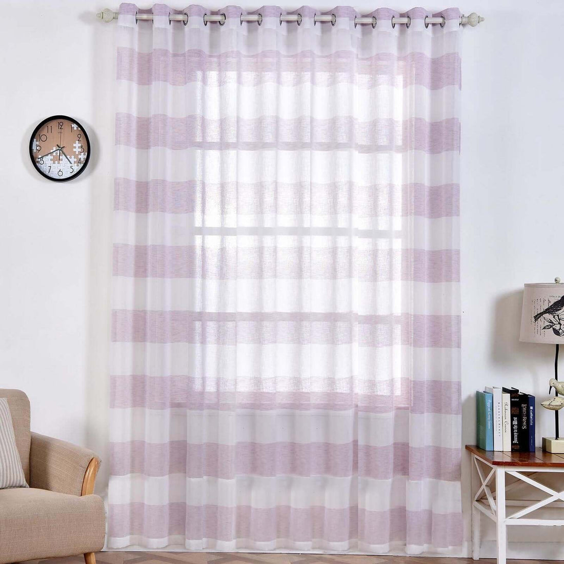 Sheer striped curtain in a living room setting with clock and lamp.