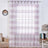Sheer striped curtain in a living room setting with clock and lamp.