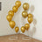 Gold balloons displayed in stylish stands for festive decor. #whtbkgd