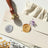 Wax seal stamp set with gold and silver seals on an envelope with dried flowers.