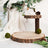 Decorative wooden display stands with natural elements and greenery.