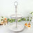 Two-tiered vintage-style cake stand with a handle, perfect for desserts.