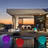 Modern outdoor patio with colorful glowing balls at sunset.