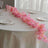 Pink floral table runner on an elegant dining table setting.