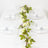 Elegant dinner table setting with clear glassware and white roses.
