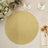 Gold glitter round placemat on a table setting with floral accents.