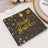 Black birthday napkin with gold "Happy Birthday" text and balloon design.