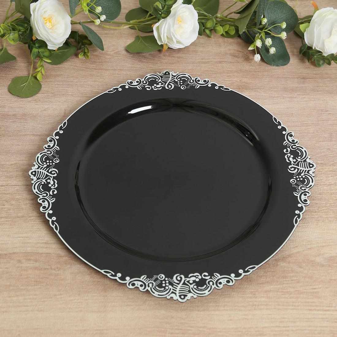 Elegant black plate with intricate white lace design.