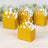 Gold crown party favor boxes with decorative cutouts.