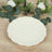 White decorative plate with scalloped edges on a wooden surface.