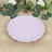 Purple scalloped plate on a wooden surface with greenery.